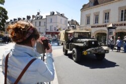 World War II history enthusiasts parade in WWII vehicles in Ouistreham, Normandy, June, 5 2021, on the eve of 77th anniversary of the assault that helped end World War II.