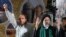 FILE - Iranian presidential candidate cleric Ebrahim Raisi, right, waves to his supporters while he is accompanied by Tehran Mayor Mohammad Bagher Qalibaf. 