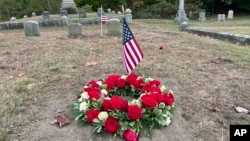 Flowers rest on the grave of Byron R. Johnson, a Union soldier who was born in Pawtucket, Rhode Island, in 1844 and fought in the Civil War, at Oak Grove Cemetery in Pawtucket, Oct. 17, 2024, after his cremated remains were transferred from storage at a cemetery in Seattle.