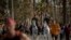 Mounted police patrol on horses as people exercise on a seafront promenade in Barcelona, Spain, Sunday, May 3, 2020.