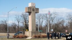 FILE - Visitors walk around the 40-foot Maryland Peace Cross dedicated to World War I soldiers.
