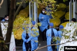 A staff member walks next to several body bags at a funeral home, as coronavirus disease (COVID-19) outbreaks continue in Shanghai, China on January 4, 2023. (REUTERS/Staff)