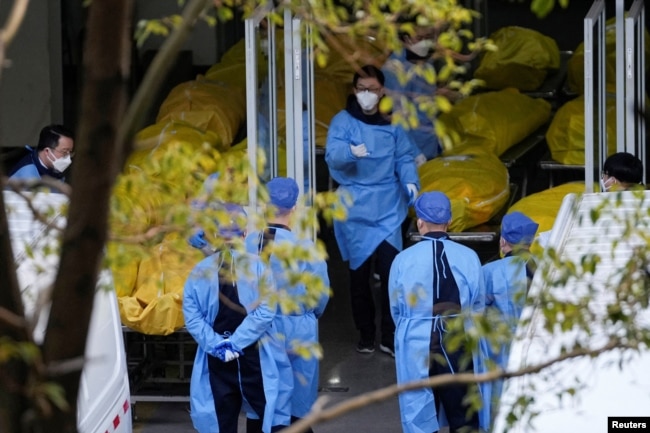 A staff member walks next to several body bags at a funeral home, as coronavirus disease (COVID-19) outbreaks continue in Shanghai, China on January 4, 2023. (REUTERS/Staff)