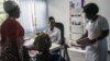 FILE - A doctor at Rabito Clinic in Accra, Ghana, takes care of a patient in her consultation room, July 3, 2018.