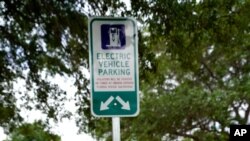 A parking area with charging stations for electric vehicles at a public park is seen April 1, 2021, in Orlando, Fla.