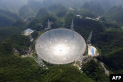 This photo taken on August 24, 2016 and released on December 13, 2020 by the National Astronomical Observatories of the Chinese Academy of Sciences (NAOC) shows the 500-meter Aperture Spherical Radio Telescope (FAST) in China's Guizhou Province.