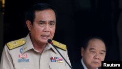Thailand's Prime Minister Prayuth Chan-ocha speaks during a news conference after his meeting with National Security Council as Deputy Prime Minister and Defense Minister Prawit Wongsuwan looks on at Government House in Bangkok, Aug. 15, 2016. 