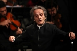 Iranian American maestro Shahrdad Rohani conducts the Tehran Symphony Orchestra at Unity Hall, in Tehran, Iran, July 3, 2019.