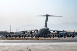 FILE - U.S. soldiers arrive to provide security for evacuees, at Hamid Karzai International Airport in Kabul, Afghanistan, Aug. 20, 2021.