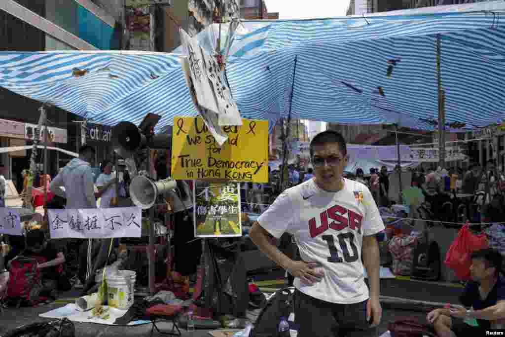 An Occupy Central movement protester stands guard on a main road at the Mong Kok shopping district in Hong Kong, Oct. 6, 2014. 