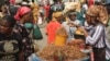 FILE - A woman sells crayfish at a market in Lagos, Nigeria, Feb. 16, 2024. With the West African nation beset by economic challenges, many are turning to a traditional community savings arrangement known as Ajo.