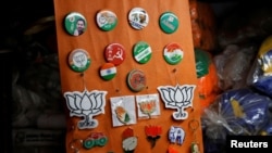 Badges of India's various political parties are displayed for sale at a market in old quarters of Delhi