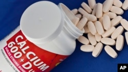 This photo shows a container of over the counter calcium supplements. A recent study found that most supplements do not help heart health and calcium with vitamin D may even harm it.