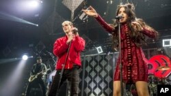 Machine Gun Kelly, left, and Camila Cabello perform at Y100's iHeartRadio Jingle Ball 2016 at BB&T Center in Sunrise, Florida. 