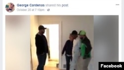 This image from a video shot by George Cardenas and posted on his Facebook page shows plainclothes Immigration and Customs Enforcement agents escorting a handcuffed Carlos Bolanos from a house in Portland, Oregon, where he and Cardenas were working. One of the agents maintained that the house was a place of business and therefore an arrest warrant was not required.