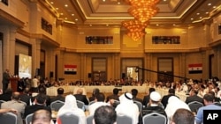 Syrian opposition leader Haitham al-Maleh (L, at podium) speaks in Istanbul, on July 16, 2011, during a meeting to discuss democratic change and voice support for a simmering revolt against President Bashar al-Assad's regime