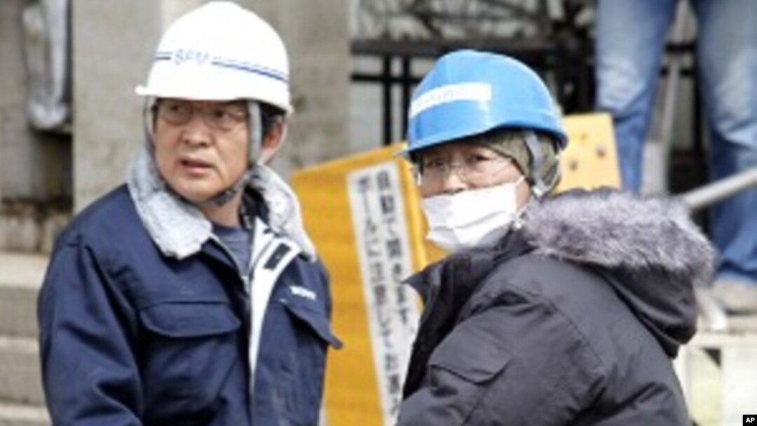 Workers transport products at Sony's tsunami-crippled warehouse near Sendai port, March 23, 2011