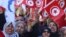 People wave national flags during demonstrations on the seventh anniversary of the toppling of president Zine El-Abidine Ben Ali, in Tunis, Jan. 14, 2018.