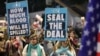 Demonstrators raise placards during an protest calling for action to secure the release of Israelis held hostage in Gaza since October 2023, in front of the Israeli defense ministry in Tel Aviv on Jan. 14, 2025.