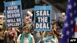 Demonstrators raise placards during an protest calling for action to secure the release of Israelis held hostage in Gaza since October 2023, in front of the Israeli defense ministry in Tel Aviv on Jan. 14, 2025.