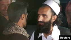 A newly freed Taliban prisoner greets his relatives outside Bagram prison, north of Kabul, Afghanistan, April 8, 2020. 