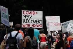 FILE - People gather during an anti-vaccine demonstration, amid the coronavirus pandemic, in Central Park, New York City, July 24, 2021.