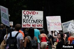 FILE - People gather during an anti-vaccine demonstration, amid the coronavirus pandemic, in Central Park, New York City, July 24, 2021.