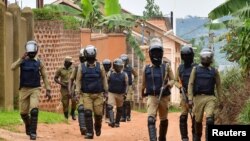 Ugandan riot police patrol an area near the house of presidential candidate and singer Robert Kyagulanyi Ssentamu, known as Bobi Wine, in the Magere neighborhood of Kampala, Uganda, Jan. 16, 2021.