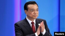 Chinese Premier Li Keqiang claps as he attends the opening ceremony of the Boao Forum for Asia (BFA) Annual Conference 2014 in Boao, Hainan province, April 10, 2014. 