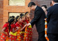 FILE - Chinese President Xi Jinping is greeted by Nepalese children upon arrival in Kathmandu, Nepal, Oct 12, 2019.