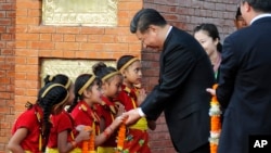 Chinese President Xi Jinping is greeted by Nepalese children upon arrival in Kathmandu, Nepal, Oct 12, 2019. 