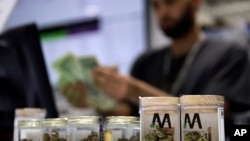 FILE - A cashier rings up a marijuana purchase at a cannabis dispensary in Las Vegas, Nevada, July 1, 2017.