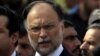 FILE - Pakistan's Interior Minister Ahsan Iqbal speaks to media outside the accountability court in Islamabad, Pakistan, Oct. 2, 2017. 