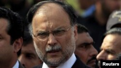 FILE - Pakistan's Interior Minister Ahsan Iqbal speaks to media outside the accountability court in Islamabad, Pakistan, Oct. 2, 2017. 
