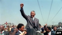 FILE — Anti-apartheid leader and African National Congress, ANC member Nelson Mandela raises his fist while addressing a crowd in Tokoza, during his tour of townships, Sept. 5, 1990 