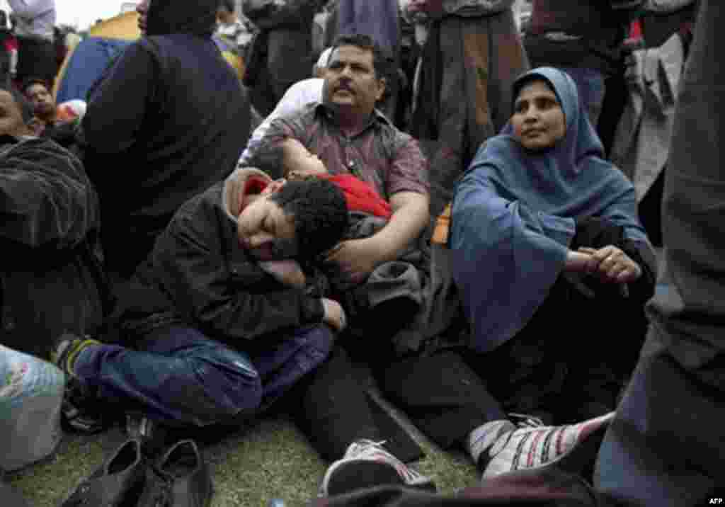 An Egyptian family rests in Tahrir, or Liberation Square in Cairo, Egypt, Tuesday, Feb. 1, 2011. More than a quarter-million people flooded into the heart of Cairo Tuesday, filling the city's main square in by far the largest demonstration in a week of un