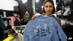 Palestinian-American Yasmeen Mjalli displays a jacket with the slogan "Not Your Habibti (darling)," as a ready-made retort for cat calls, in the West Bank city of Ramallah, Jan. 24, 2018. The 21-year-old is the driving force behind a nascent #MeToo movement in the West Bank, selling her line of T-shirts, hoodies and denim jackets, to encourage Palestinian society to confront sexual harassment, a largely taboo subject.