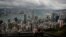 FILE - A visitor sets up his camera in the Victoria Peak area to photograph Hong Kong's skyline, Sept. 1, 2019. 