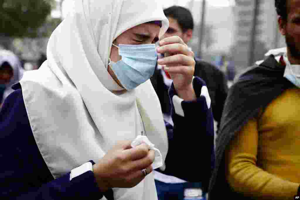 A protester winces with pain from tear gas. (VOA - Y. Weeks)