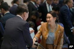 South Korean President Yoon, left, shakes hands with Thailand's Prime Minister Paetongtarn Shinawatra at the 25th ASEAN - South Korea Summit to commemorate the 35th Anniversary of Dialogue Relation in Vientiane, Laos, Oct. 10, 2024.