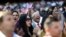 Alfonso Perez, of the Dominican Republic, cheers at the start of a naturalization ceremony for 755 new United States citizens at Turner Field, home of the Atlanta Braves baseball team in Atlanta, Sept. 16, 2016. 