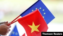 European Union and Vietnamese flags are seen at the signing ceremony of the of EU-Vietnam Free Trade Agreement, June 30, 2019, in Hanoi.
