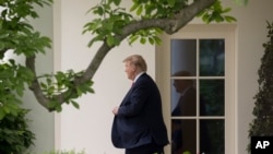 FILE - President Donald Trump walks out of the Oval Office of the White House in Washington, May 8, 2019.