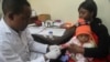 FILE - A doctor tests a child for malaria at the Ithani-Asheri Hospital in Arusha, Tanzania, May 11, 2016. 