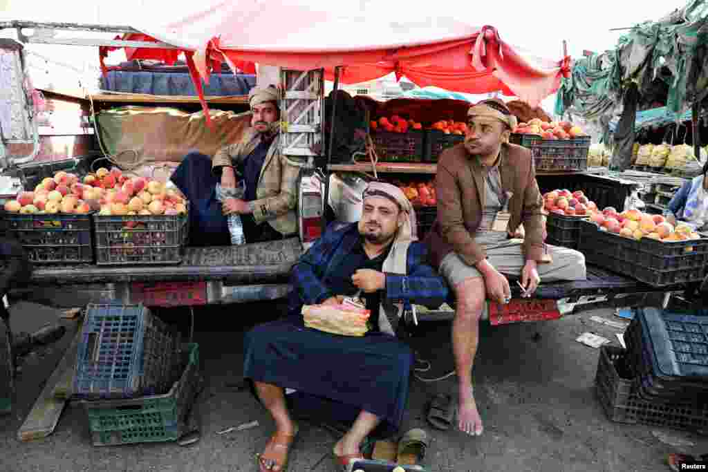 Fruit vendors chew qat, a mild stimulant at a fruit market in Sana&#39;a, Yemen.