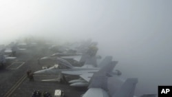 U.S. Navy F/A-18F Super Hornet fighter jets sit in heavy fog on the deck of the USS George Washington, during a joint military exercise off South Korea's West Sea. (File)