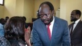 South Sudanese activist and economist Peter Biar Ajak talks to his wife Nyathon Hoth Mai after he was sentenced to two years in prison, in Juba, South Sudan, June 11, 2019. 