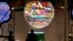 Visitors walk past a sphere featuring flags of countries of the world displayed at the pavillion of India on Nov. 8, 2017, during the COP23 U.N. Climate Change Conference in Bonn, Germany.
