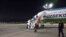 People disembark from a plane upon their arrival from Syria at an airport in Tashkent, Uzbekistan, April 30, 2021. Uzbekistan brought home women and children from Syria where they had been staying at camps with other families of Islamic State fighters.