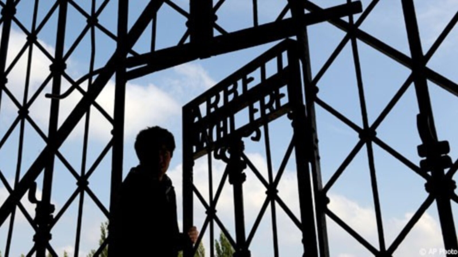 FILE - A visitor enters the Dachau Nazi concentration camp in Germany.